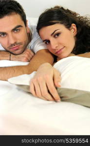 Attractive couple lying in bed