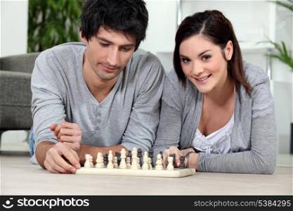 Attractive couple playing chess