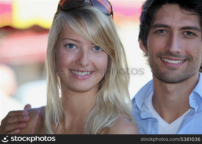 Attractive couple stood by market