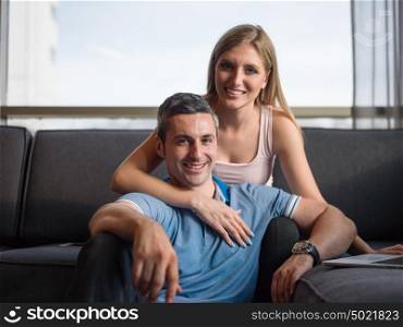 Attractive couple using a laptop in the living room