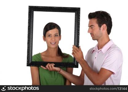 Attractive couple with frame