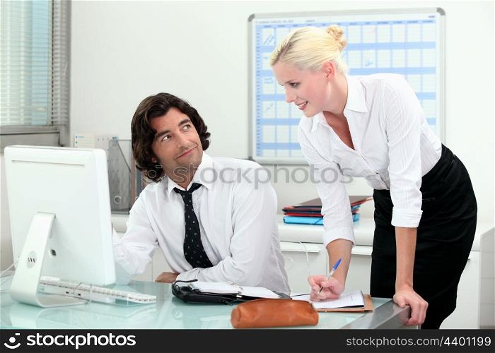 Attractive couple working in an office