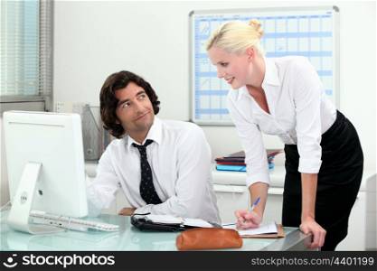 Attractive couple working in an office
