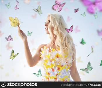 Attractive delicate woman playing with butterflies