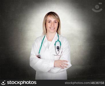 Attractive doctor with blue uniform and a irregular grey background