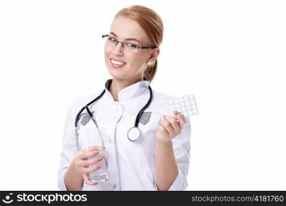 Attractive doctor with pills and a glass of water on a white background