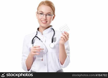 Attractive doctor with pills on white background