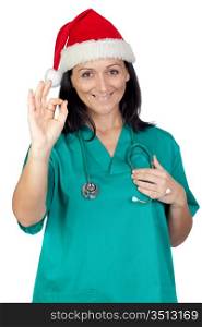Attractive doctor woman with Christmas hat saying Ok isolated on white