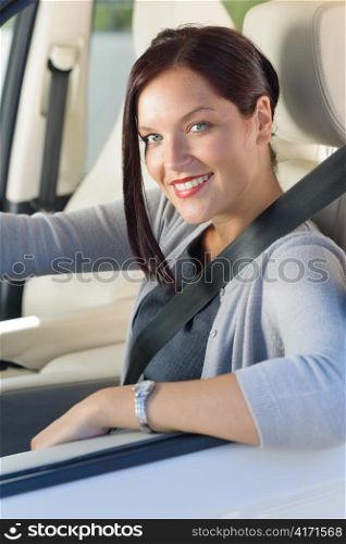 Attractive elegant businesswoman driving luxury new car concentrating