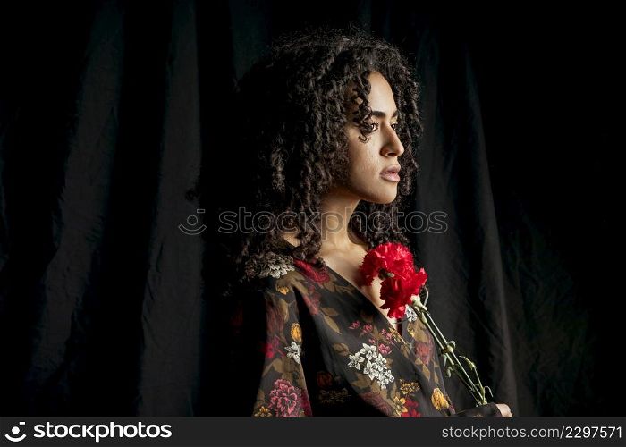 attractive ethnic woman with red flowers dark