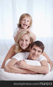 Attractive family in their pajamas on the bed