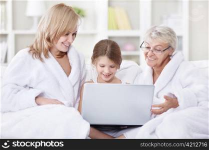 Attractive family is looking into a laptop
