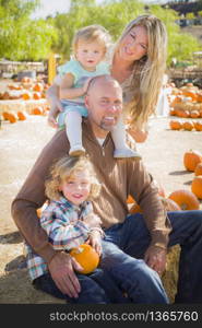 Attractive Family Portrait in a Rustic Ranch Setting at the Pumpkin Patch.