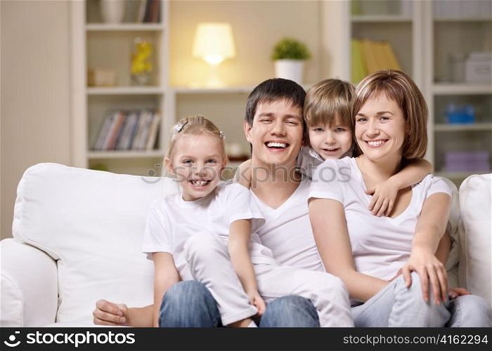 Attractive family with children at home in the evening