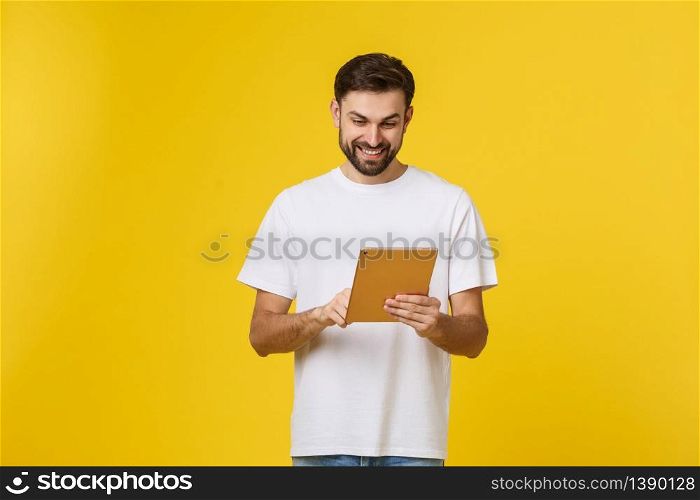 Attractive fashionable young Caucasian man working on touch pad pc, making presentation, using wireless high speed internet connection. Attractive fashionable young Caucasian man working on touch pad pc, making presentation, using wireless high speed internet connection.