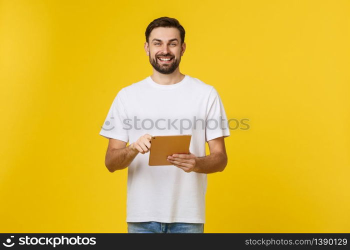 Attractive fashionable young Caucasian man working on touch pad pc, making presentation, using wireless high speed internet connection. Attractive fashionable young Caucasian man working on touch pad pc, making presentation, using wireless high speed internet connection.