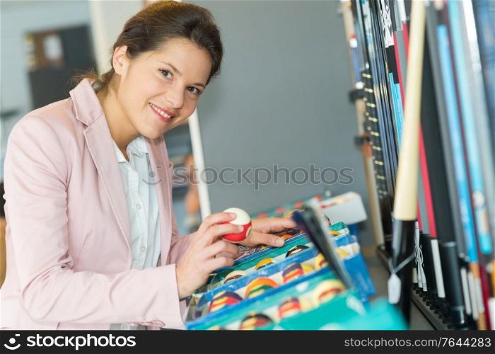 attractive female billiard player choosing balls