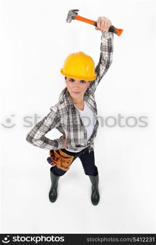 Attractive female builder holding hammer