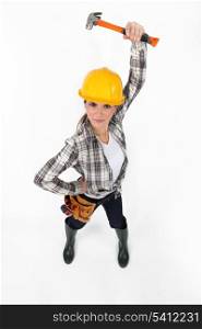 Attractive female builder holding hammer