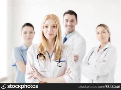 attractive female doctor in front of medical group