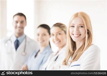 attractive female doctor in front of medical group