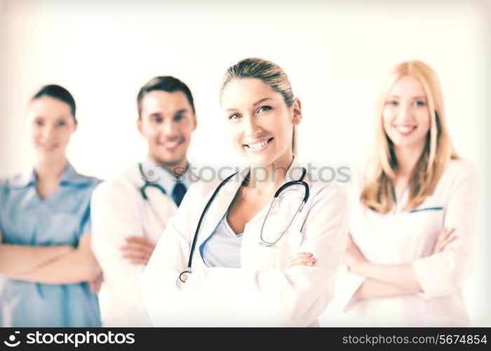 attractive female doctor in front of medical group