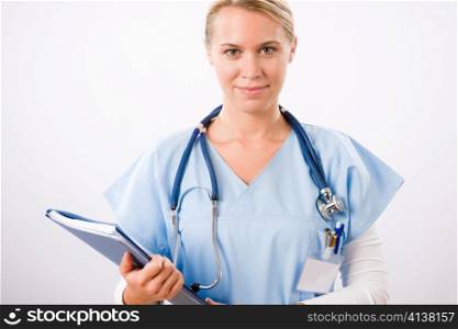 Attractive female doctor standing with stethoscope and folders isolated portrait