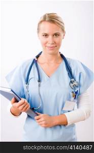 Attractive female doctor standing with stethoscope and folders isolated portrait