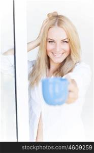 Attractive female having morning coffee at home near window, happy lifestyle, pleasure concept
