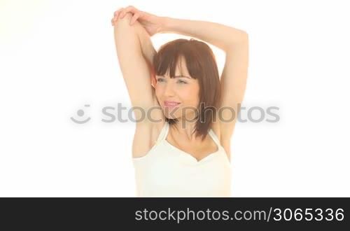 Attractive female stretching herself on white background