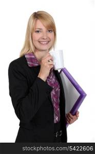 attractive female student holding mug of coffee and files