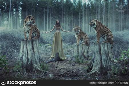 Attractive female trainer with the wild tigers