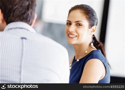 Attractive female worker in office. Attractive female woman in office with colleagues