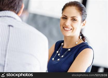 Attractive female worker in office. Attractive female woman in office with colleagues