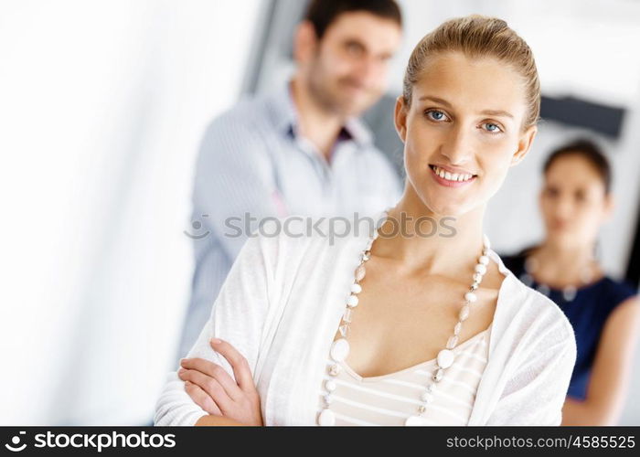 Attractive female worker in office. Attractive female woman in office with colleagues on background