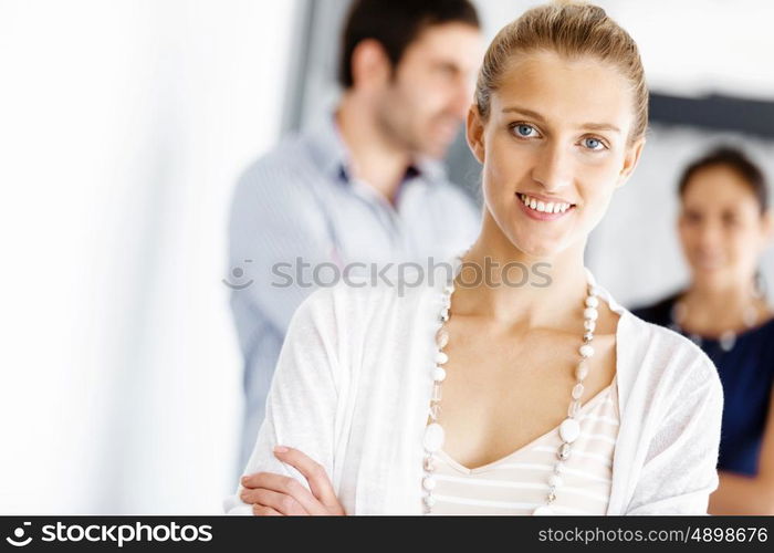 Attractive female worker in office. Attractive female woman in office with colleagues on background