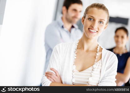 Attractive female worker in office. Attractive female woman in office with colleagues on background