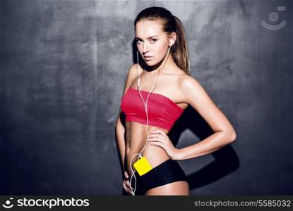 attractive fitness woman in red top with mp3 player, caucasian brunette model