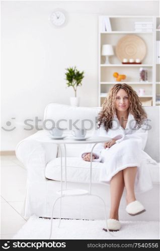 Attractive girl in a bathrobe at home