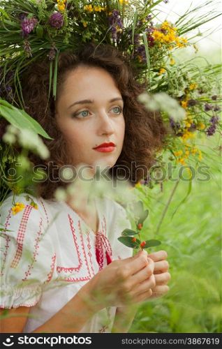 attractive girl in a meadow with a wreath