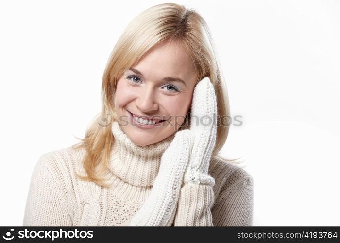Attractive girl in a sweater and knitted mittens