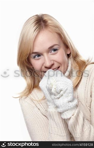 Attractive girl in a sweater and mittens