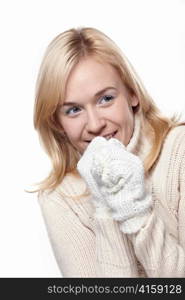 Attractive girl in a sweater and mittens