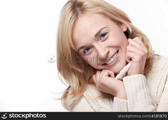 Attractive girl in a sweater with a white background