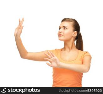 attractive girl in blank color t-shirt working with something imaginary