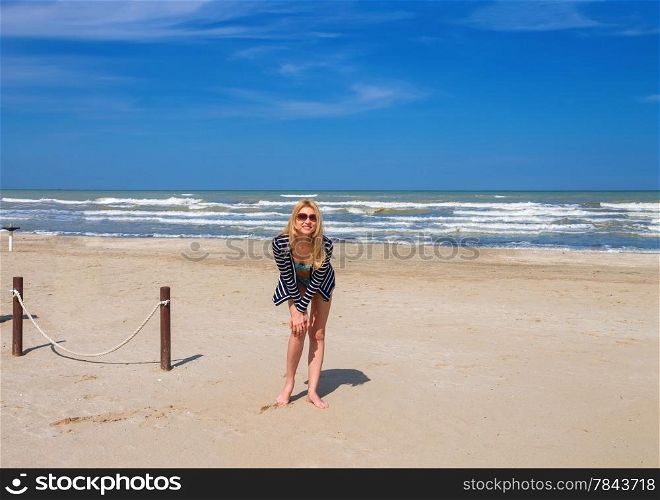 Attractive girl in sunglasses on the beach spring