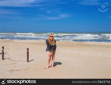 Attractive girl in sunglasses on the beach spring