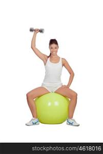 Attractive girl lifting weights sitting on a ball isolated on white background