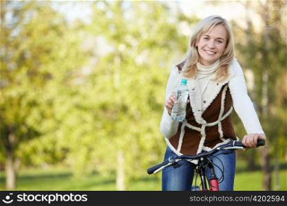 Attractive girl on a bicycle in the autumn park
