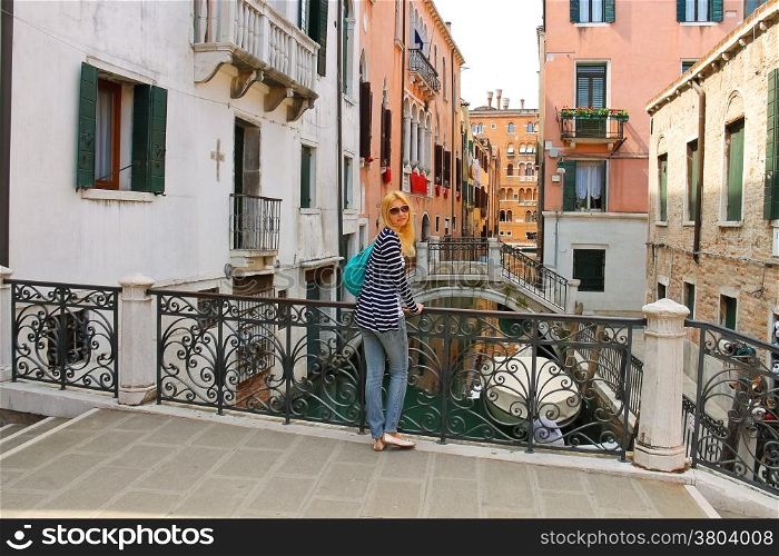 Attractive girl on a bridge in Venice, Italy